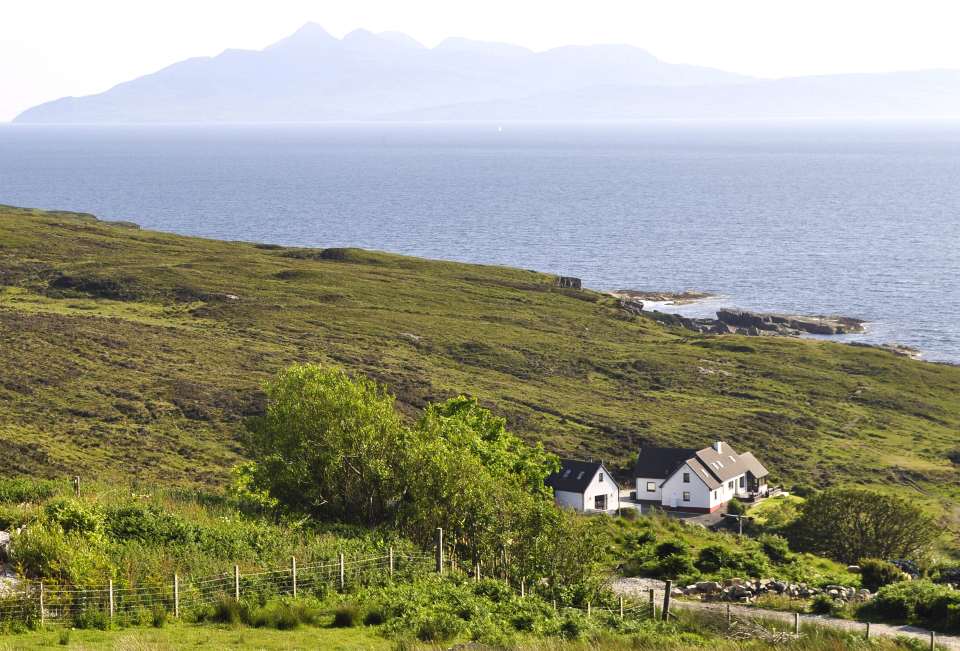 Shore Cottage and Pier House with the Isle of Rhum in the background
